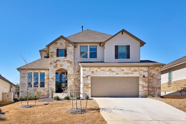 view of front of house featuring stone siding, driveway, an attached garage, and roof with shingles