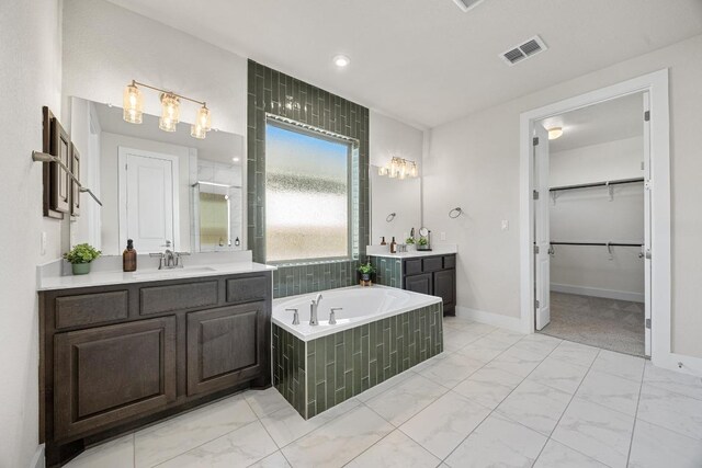 bathroom featuring a shower stall, visible vents, marble finish floor, and a sink