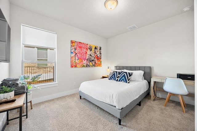 bedroom with baseboards, visible vents, and carpet floors