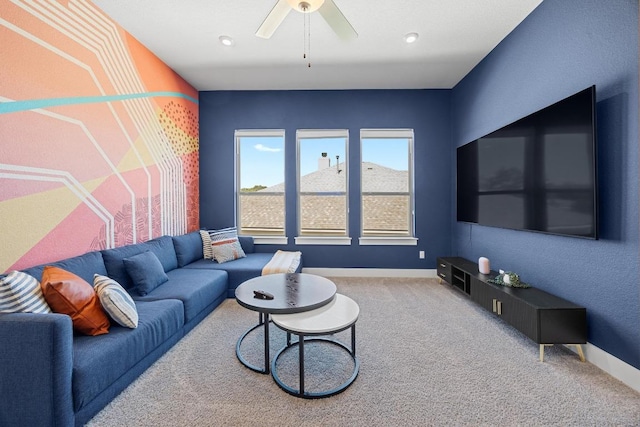 carpeted living area featuring ceiling fan and baseboards