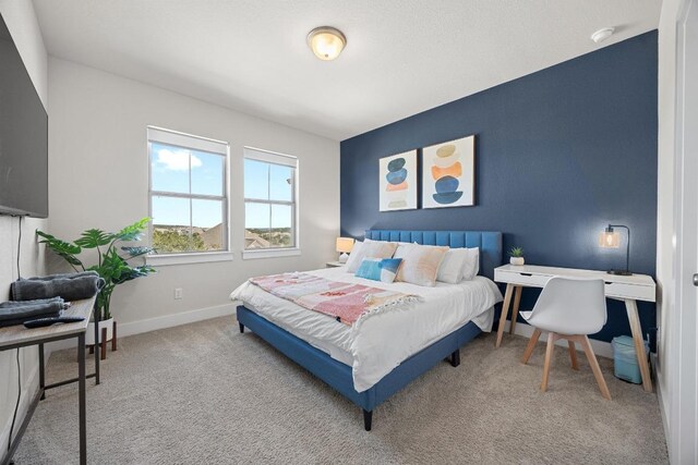 carpeted bedroom featuring baseboards