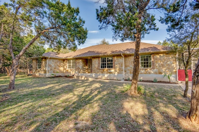 view of front of house with stone siding and a front lawn