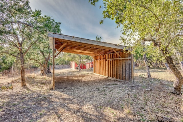 view of yard with a carport, an outdoor structure, and a pole building