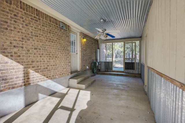 unfurnished sunroom with a ceiling fan