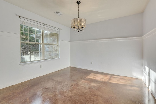 spare room with a chandelier, visible vents, and concrete flooring