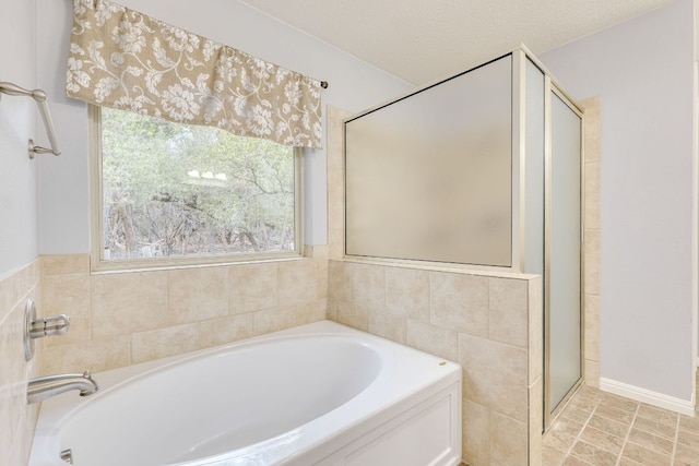 full bathroom featuring a garden tub and a shower stall