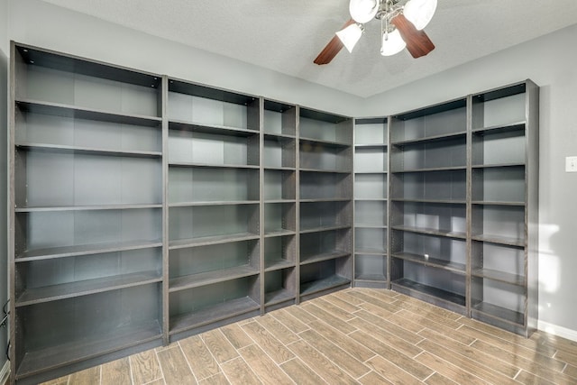 spacious closet with a ceiling fan and wood tiled floor