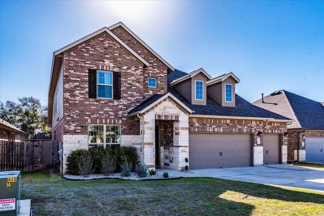 view of front of property with a garage, brick siding, and fence