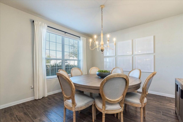 dining space with baseboards, a notable chandelier, and dark wood-style flooring