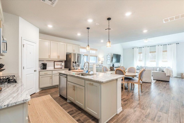 kitchen featuring a sink, open floor plan, visible vents, and stainless steel appliances