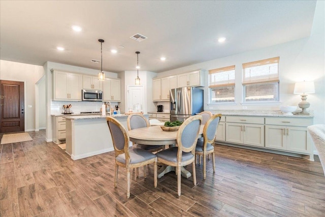 dining area featuring visible vents, recessed lighting, baseboards, and wood finished floors