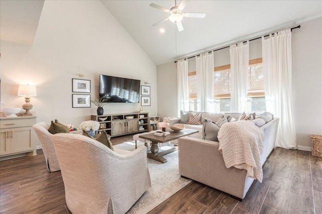 living area with dark wood-type flooring, a ceiling fan, and high vaulted ceiling