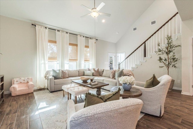 living room with stairs, wood finished floors, visible vents, and high vaulted ceiling