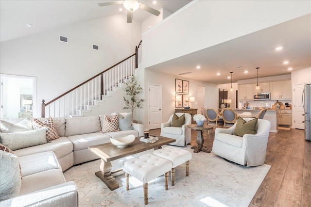 living area featuring stairway, recessed lighting, light wood-type flooring, and visible vents