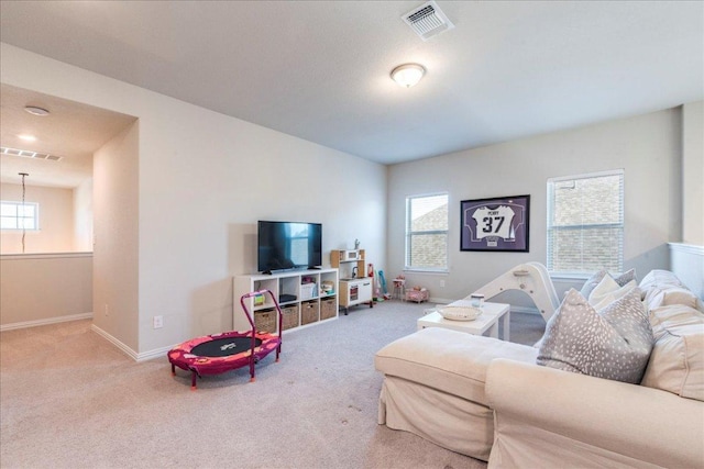 living area featuring visible vents, baseboards, and carpet floors