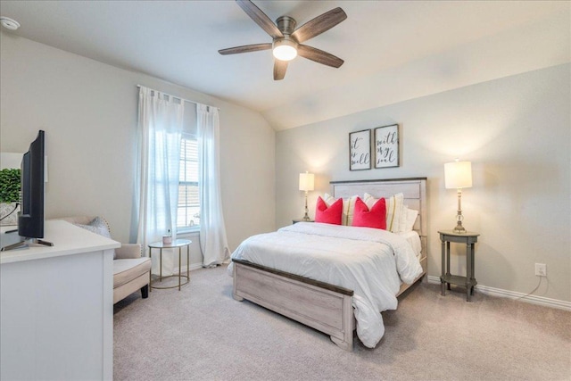 carpeted bedroom with vaulted ceiling, a ceiling fan, and baseboards