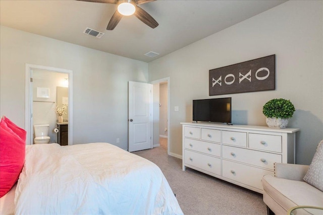 bedroom featuring connected bathroom, a ceiling fan, visible vents, and light carpet