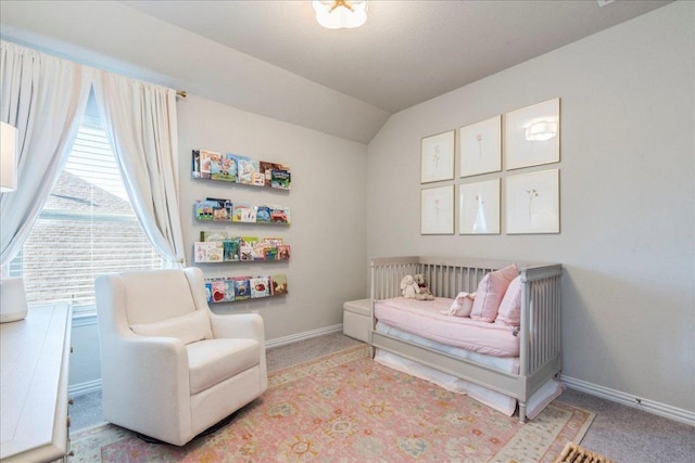 carpeted bedroom featuring vaulted ceiling and baseboards