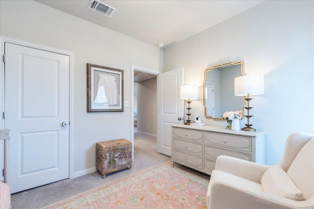 living area featuring light colored carpet, visible vents, and baseboards