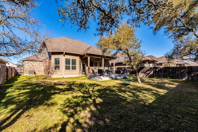 back of house featuring a patio, central AC unit, a fenced backyard, and a lawn