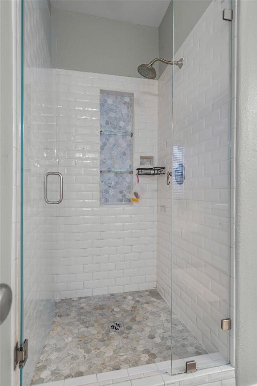 full bath with a shower stall