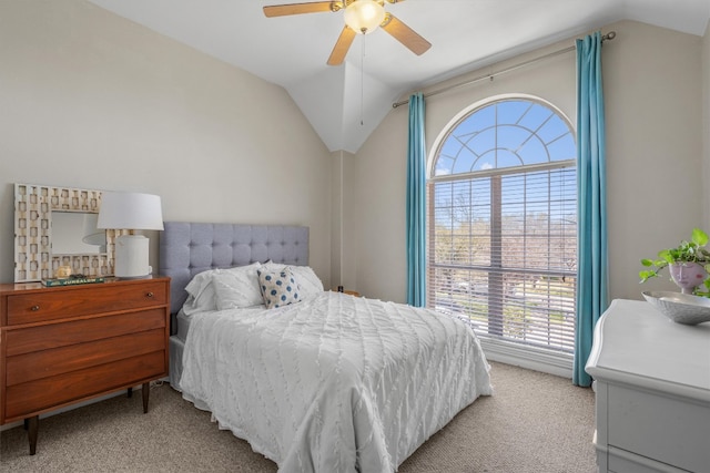 bedroom featuring lofted ceiling, light colored carpet, and ceiling fan