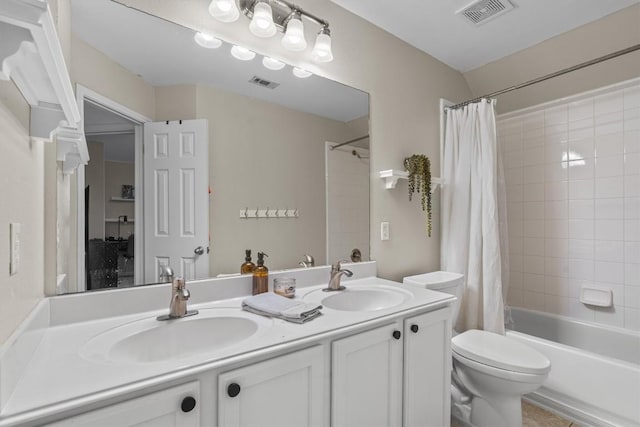 bathroom featuring visible vents, toilet, and a sink