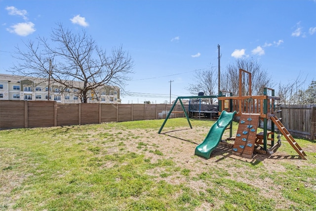 view of jungle gym with a lawn and a fenced backyard