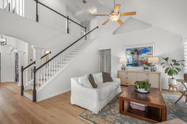 1617 Shady Hillside Pass, Round Rock, TX 78665 - living room with light wood-style flooring, arched walkways, ornate columns, a ceiling fan, and high vaulted ceiling