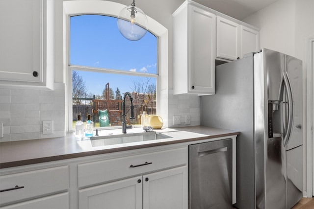 1617 Shady Hillside Pass, Round Rock, TX 78665 - kitchen featuring stainless steel appliances, white cabinetry, decorative backsplash, and light countertops