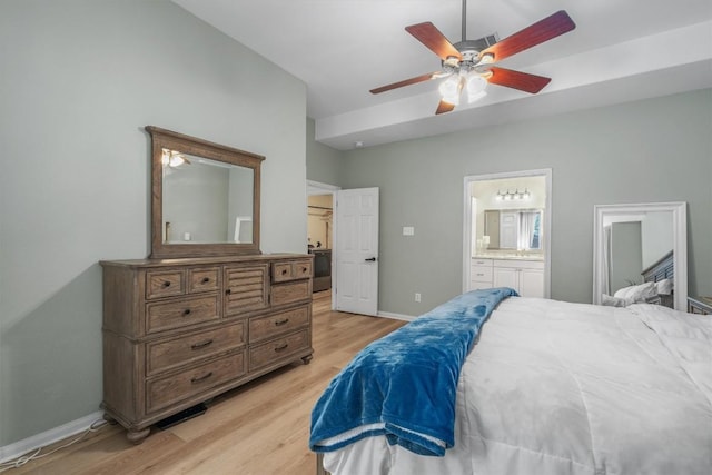 bedroom featuring ceiling fan, light wood-type flooring, baseboards, and connected bathroom