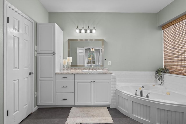 1617 Shady Hillside Pass, Round Rock, TX 78665 - bathroom featuring vanity, a garden tub, a ceiling fan, and tile patterned flooring