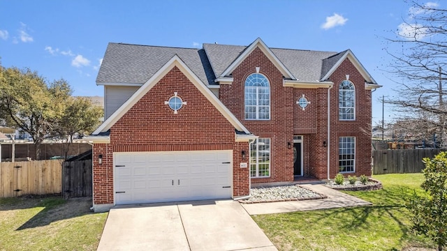 traditional-style home with brick siding, an attached garage, fence, a front yard, and driveway