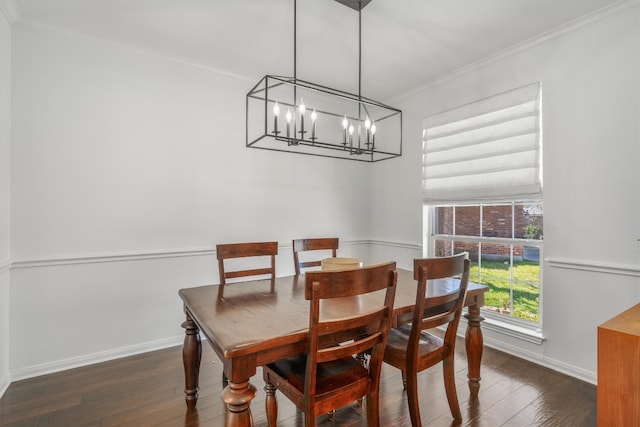 dining room featuring a chandelier, crown molding, baseboards, and wood-type flooring