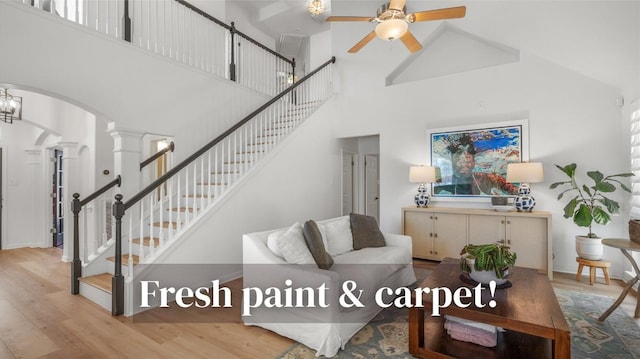 1617 Shady Hillside Pass, Round Rock, TX 78665 - living room with high vaulted ceiling, arched walkways, ornate columns, wood finished floors, and ceiling fan