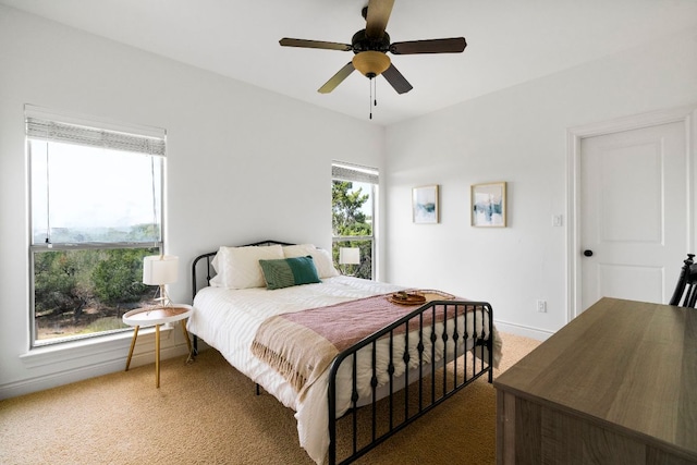 carpeted bedroom with baseboards and ceiling fan