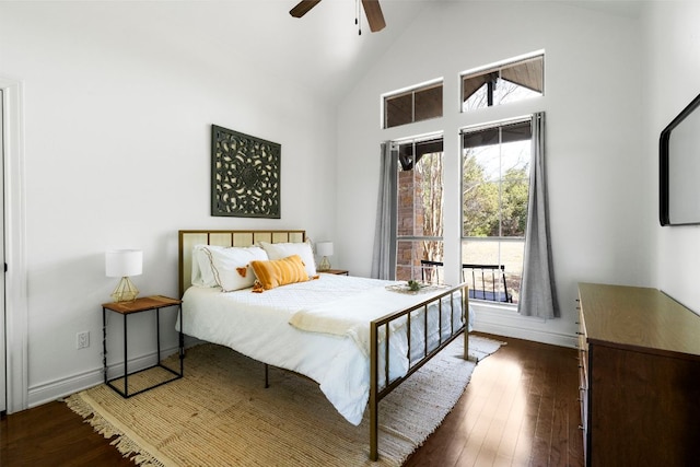 bedroom with baseboards, high vaulted ceiling, wood finished floors, and a ceiling fan