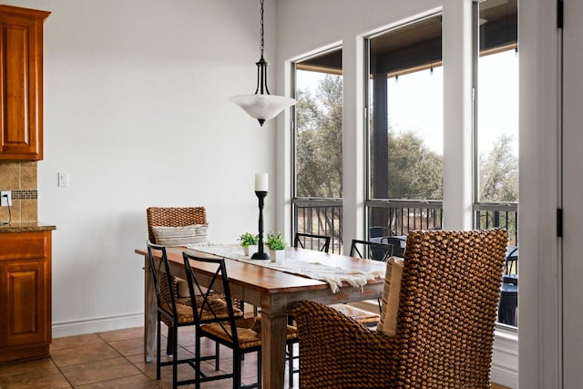 dining room with tile patterned flooring and baseboards