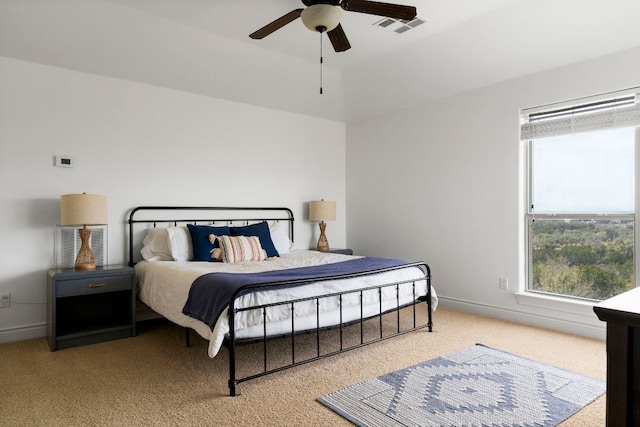 bedroom featuring visible vents, baseboards, carpet floors, and a ceiling fan