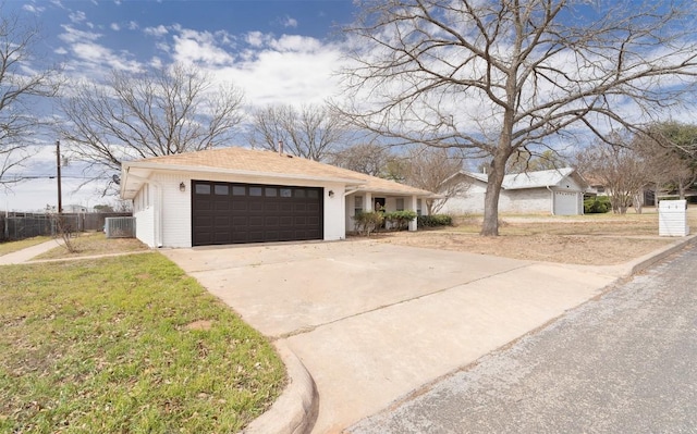 view of front of home with fence, driveway, central AC, a garage, and brick siding