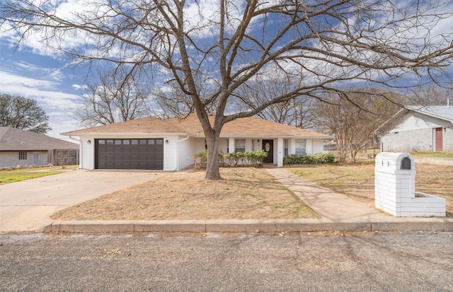 view of front of home with driveway and a garage