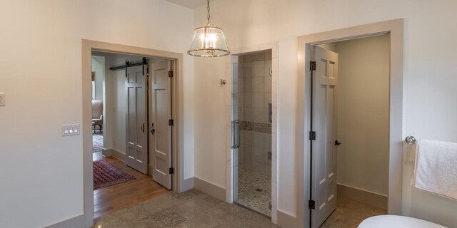 full bath with a shower stall and baseboards