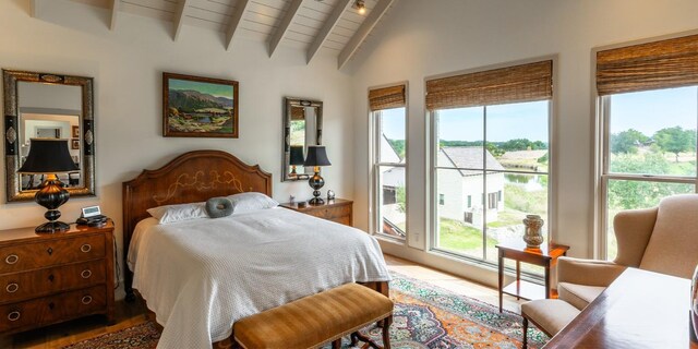 bedroom featuring multiple windows, vaulted ceiling with beams, and wood ceiling