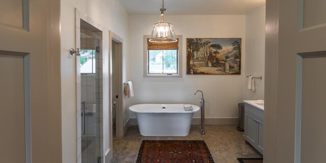 bathroom featuring baseboards, a soaking tub, a stall shower, and vanity