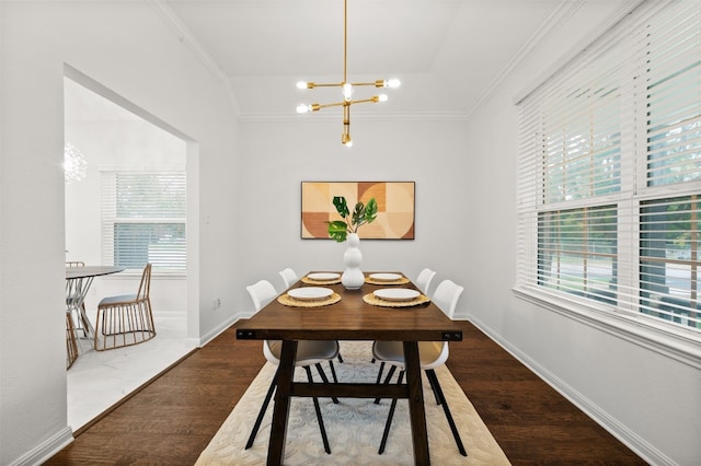 dining space with wood finished floors, a wealth of natural light, and ornamental molding