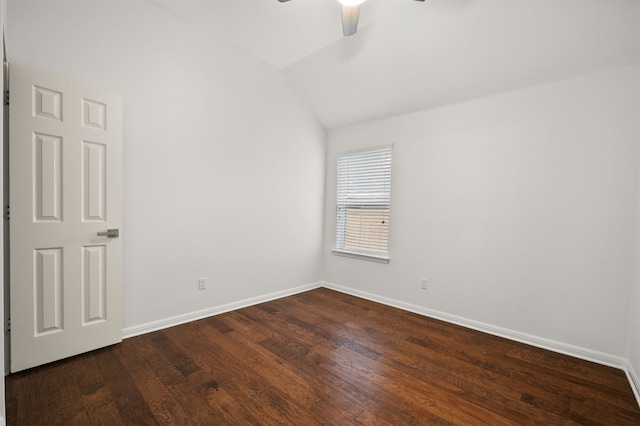 spare room featuring dark wood-style floors, lofted ceiling, baseboards, and ceiling fan