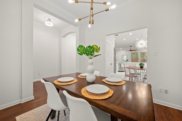 dining area with baseboards, ornamental molding, recessed lighting, wood finished floors, and arched walkways