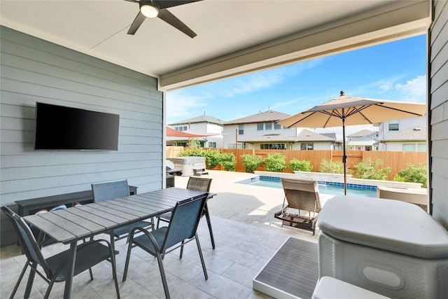 view of patio featuring a ceiling fan, outdoor dining area, a fenced backyard, and a fenced in pool