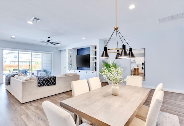 dining space featuring visible vents and light wood-style flooring