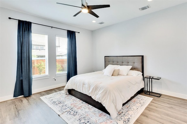 bedroom featuring wood finished floors, recessed lighting, baseboards, and visible vents